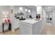 Updated kitchen featuring white cabinets, stainless steel appliances and a breakfast bar at 6946 Woodwind Dr # 2, Sarasota, FL 34231
