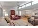 Open-concept living and dining room featuring high ceilings, tile floors and a large cabinet at 6946 Woodwind Dr # 2, Sarasota, FL 34231