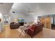 Living room area featuring tile floors, neutral-toned sofas, and a sliding glass door at 6946 Woodwind Dr # 2, Sarasota, FL 34231