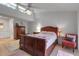 Bright bedroom featuring a ceiling fan, wood furniture, and large windows at 6946 Woodwind Dr # 2, Sarasota, FL 34231