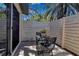 Private outdoor patio with table and chairs, perfect for relaxing or entertaining at 6946 Woodwind Dr # 2, Sarasota, FL 34231