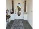 Inviting entryway with decorative accents, tiled floor, and a glass-paneled front door at 7036 Clark Rd, Sarasota, FL 34241