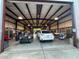 Spacious garage with multiple vehicles, and organizational shelves and cabinets perfect for storage at 7036 Clark Rd, Sarasota, FL 34241