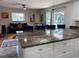 Open concept living space with a kitchen island, comfortable seating, and stylish decor at 7036 Clark Rd, Sarasota, FL 34241