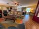 Spacious living room with a stone fireplace, comfortable seating, and expansive windows, perfect for gatherings at 7036 Clark Rd, Sarasota, FL 34241