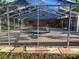 A screened-in pool area with outdoor seating and a view of the building at 7036 Clark Rd, Sarasota, FL 34241