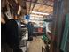A storage room with wood floors and walls containing assorted boxes, containers and household items at 7036 Clark Rd, Sarasota, FL 34241