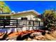 A private backyard space showing a raised concrete patio area with a black fence and mature trees at 7314 Mauna Loa Blvd, Sarasota, FL 34241