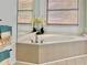 Bathroom featuring a large soaking tub with neutral tile and natural light at 7314 Mauna Loa Blvd, Sarasota, FL 34241