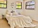 Bright bedroom featuring three windows and a comfortable, inviting bed at 7314 Mauna Loa Blvd, Sarasota, FL 34241