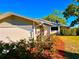 Charming one-story home showcasing a well-manicured front yard and an attached garage with lush landscaping at 7314 Mauna Loa Blvd, Sarasota, FL 34241