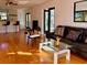Cozy living room space featuring hardwood floors, a fireplace, and stylish furniture at 7314 Mauna Loa Blvd, Sarasota, FL 34241