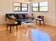 Well-lit living room featuring a stylish couch, hardwood floors, and modern decor at 7314 Mauna Loa Blvd, Sarasota, FL 34241