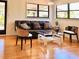 Bright and airy living room with hardwood floors and a stylish seating arrangement near large windows at 7314 Mauna Loa Blvd, Sarasota, FL 34241