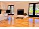 A brightly lit living room featuring a sleek fireplace, hardwood floors, and contemporary decor at 7314 Mauna Loa Blvd, Sarasota, FL 34241