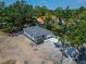 An elevated aerial view captures the home's position amidst lush trees at 732 15Th E St, Bradenton, FL 34208