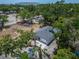 Aerial view showcases the home's new roof, attached garage, and lush surrounding landscape at 732 15Th E St, Bradenton, FL 34208