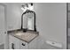 Bathroom featuring a modern black faucet and gray countertop over white cabinetry at 732 15Th E St, Bradenton, FL 34208
