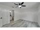 Bedroom with gray wood-look flooring and ceiling fan, with an en-suite bathroom at 732 15Th E St, Bradenton, FL 34208