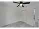 Bedroom with gray wood-look flooring, ceiling fan, closet, and access to other rooms at 732 15Th E St, Bradenton, FL 34208