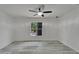 Bedroom with gray wood-look flooring and ceiling fan with a view out the window at 732 15Th E St, Bradenton, FL 34208