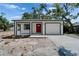 Charming single-story home boasts a bright red front door and an attached one car garage at 732 15Th E St, Bradenton, FL 34208