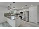 This updated kitchen features stainless steel appliances, a gray marbled countertop, and bright white cabinetry at 732 15Th E St, Bradenton, FL 34208