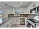 Updated kitchen featuring stainless appliances, white cabinets, gray countertops, and a modern faucet at 732 15Th E St, Bradenton, FL 34208
