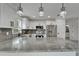 Modern kitchen featuring white cabinets, gray countertops, stainless appliances and stylish pendant lighting at 732 15Th E St, Bradenton, FL 34208