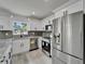 Bright kitchen with stainless steel appliances, gray countertops, and white cabinetry at 732 15Th E St, Bradenton, FL 34208