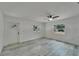 Bright living room with neutral walls, ceiling fan and wood-look tile flooring at 732 15Th E St, Bradenton, FL 34208