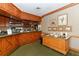 Full bar in clubhouse with wood cabinetry and framed artwork at 7687 Sweetbay Cir # 7687, Bradenton, FL 34203