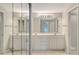 Elegant bathroom with double vanity, large mirror, bright lighting, and a glass-enclosed shower stall at 7687 Sweetbay Cir # 7687, Bradenton, FL 34203