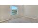 Inviting bedroom with a view of a tranquil lake, soft carpeting, and ample natural light at 7687 Sweetbay Cir # 7687, Bradenton, FL 34203