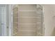 Organized walk-in closet with multiple shelves for ample storage and a bright, clean appearance at 7687 Sweetbay Cir # 7687, Bradenton, FL 34203