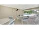 This community area provides plenty of tables, chairs, and a fan for relaxing at 7687 Sweetbay Cir # 7687, Bradenton, FL 34203