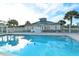 Community pool featuring clear blue water and a building in the background at 7687 Sweetbay Cir # 7687, Bradenton, FL 34203