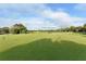 Expansive green golf course putting green with flags on a sunny day at 7687 Sweetbay Cir # 7687, Bradenton, FL 34203