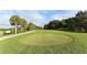 Picturesque golf course tee box with lush green grass and scattered trees at 7687 Sweetbay Cir # 7687, Bradenton, FL 34203