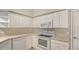 Bright kitchen with modern white appliances and plenty of cabinet space at 7687 Sweetbay Cir # 7687, Bradenton, FL 34203