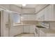 Modern kitchen featuring sleek, white appliances and ample cabinet space at 7687 Sweetbay Cir # 7687, Bradenton, FL 34203