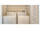 Bright laundry area features a full-size washer and dryer with ample storage space at 7687 Sweetbay Cir # 7687, Bradenton, FL 34203