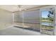 Relaxing screened patio with views of the lake, ceiling fan and access door at 7687 Sweetbay Cir # 7687, Bradenton, FL 34203