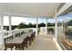 Covered patio with golf course views, seating and tile flooring at 7687 Sweetbay Cir # 7687, Bradenton, FL 34203
