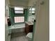 Cozy bathroom featuring a bathtub, vanity, toilet, and unique green tiling at 775 Liberty St, Englewood, FL 34223