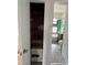 A small walk-in closet leading to the bathroom at 775 Liberty St, Englewood, FL 34223