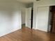 Bright bedroom featuring wood floors, closet, and a neutral color scheme at 775 Liberty St, Englewood, FL 34223