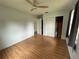 A bedroom with wood floors, a ceiling fan, and closet at 775 Liberty St, Englewood, FL 34223