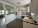 This stylish kitchen features white cabinets, butcher block countertops, and is open to the living room at 775 Liberty St, Englewood, FL 34223