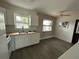 Cozy kitchen with stylish cabinets, butcher block countertops, stainless sink, and abundant natural light at 775 Liberty St, Englewood, FL 34223